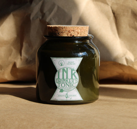 Inkdrinker's Tonic: 8oz wood-wick candle in green jar